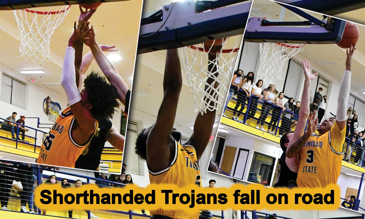 Shorthanded Trojans fall on road